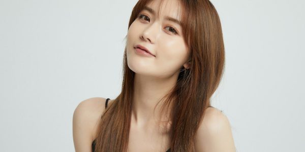 a woman with long hair and a black top